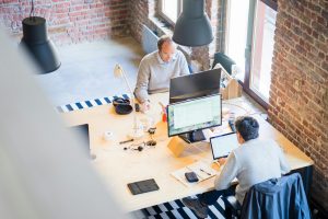 startup company room filled with two men owrking on the same table